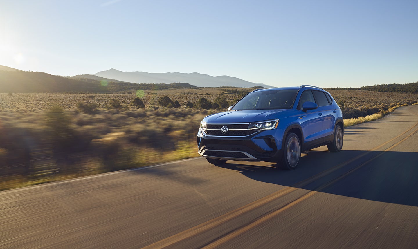 The 2022 Volkswagen Taos driving in the desert.