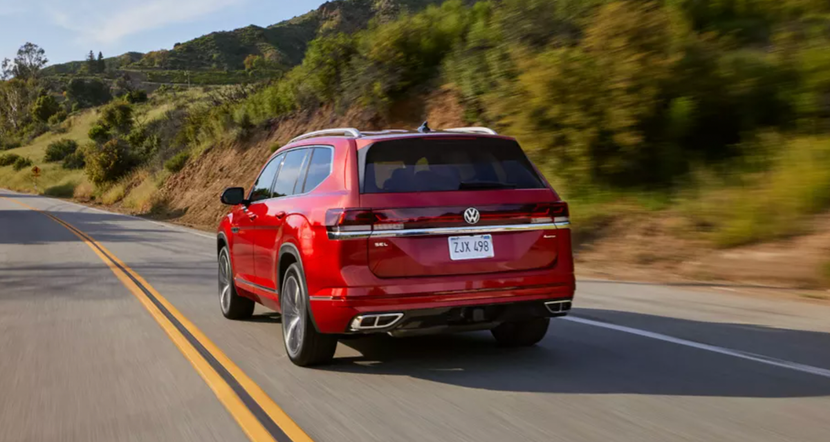 Rear view of a red 2024 VW Atlas driving