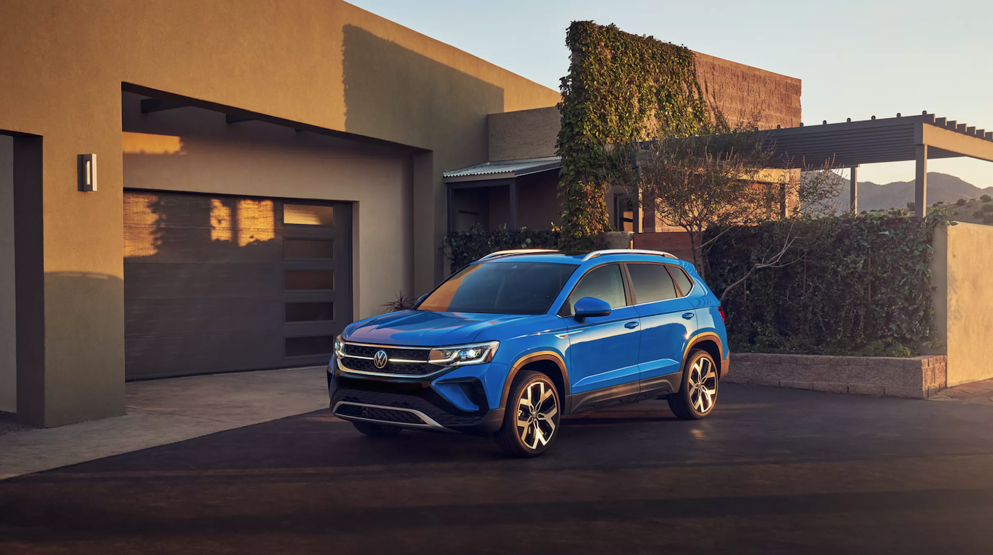 The 2022 VW Taos parked in front of a house.