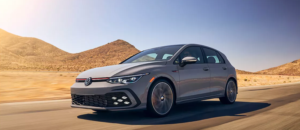 2023 Volkswagen Golf GTI driving on sandy road