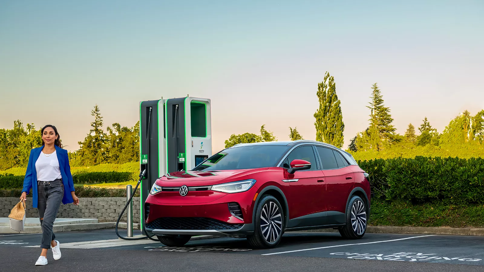 Person walking away from a Volkswagen EV charging 